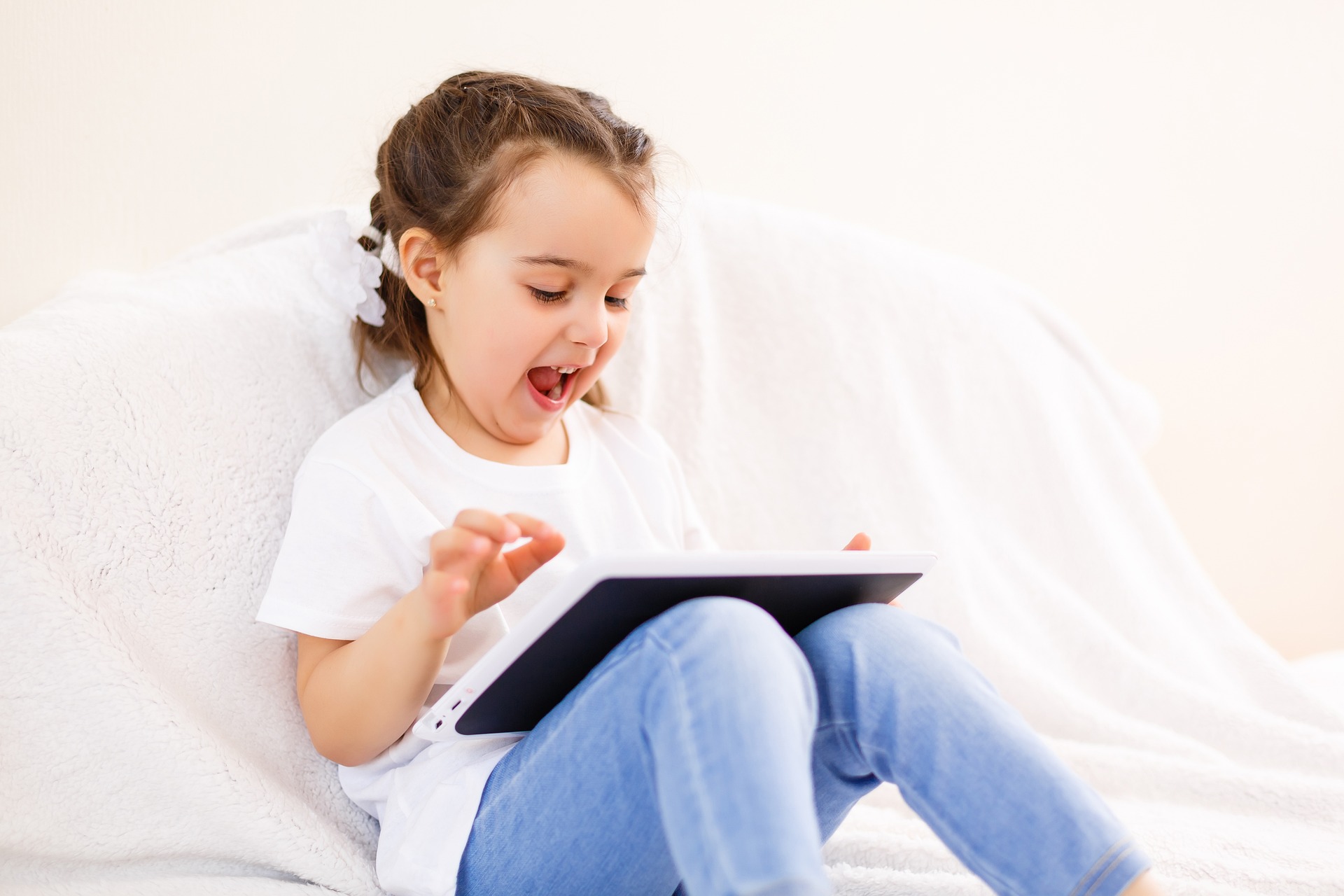 A young child playing on a tablet