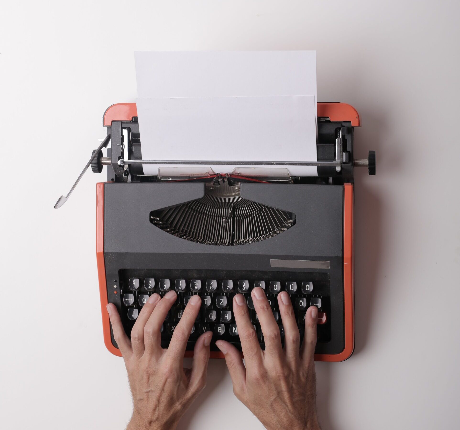 Hands typing on a typewriter