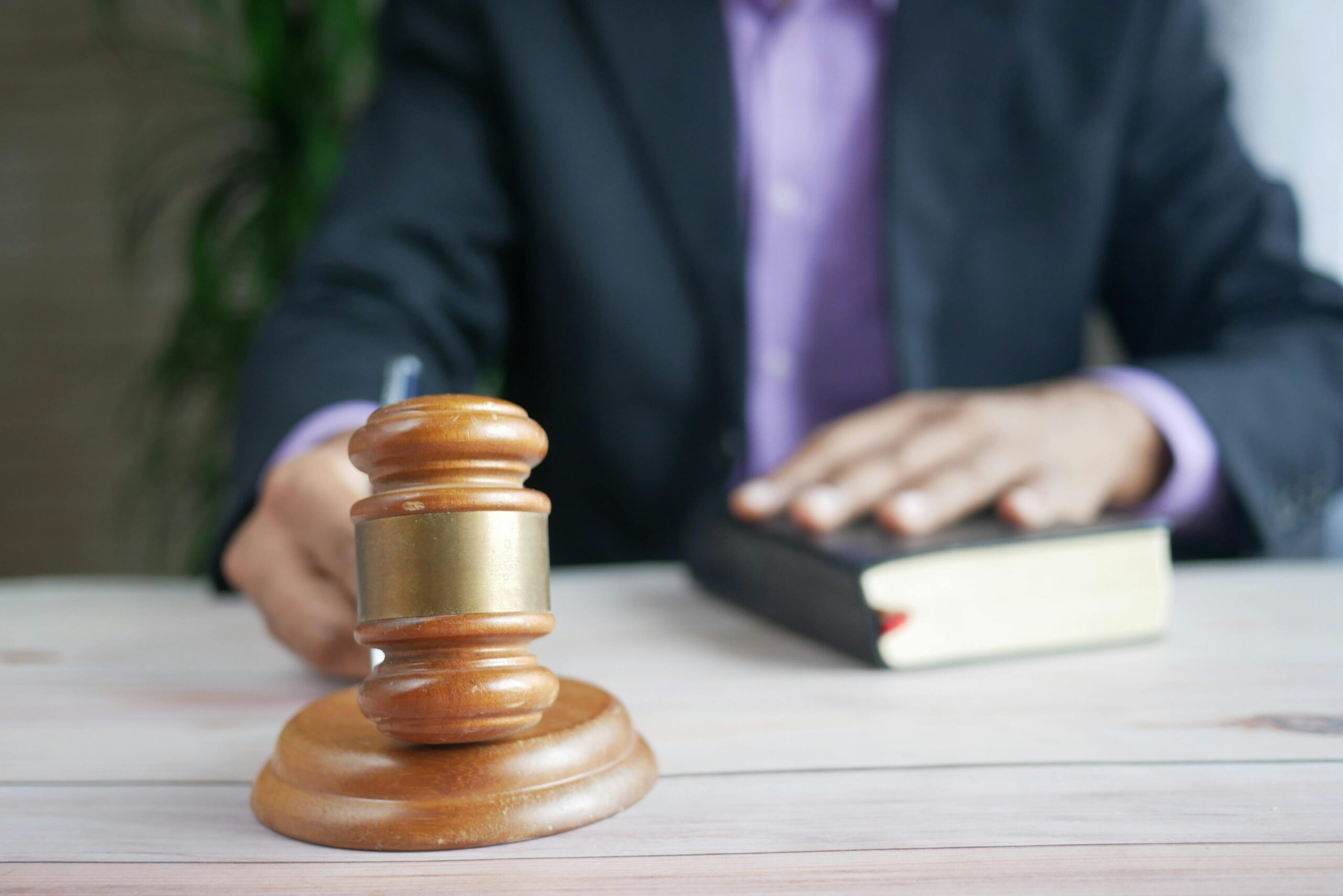 Man banging a gavel, with books in front of him